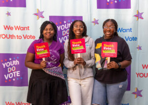 Youth Volunteers holding up Youth Vote Matters signs at a Youth do Vote event!